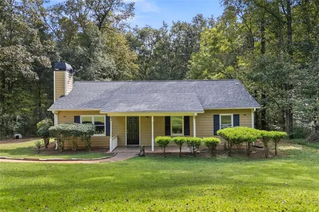 a front view of a house with a garden and porch