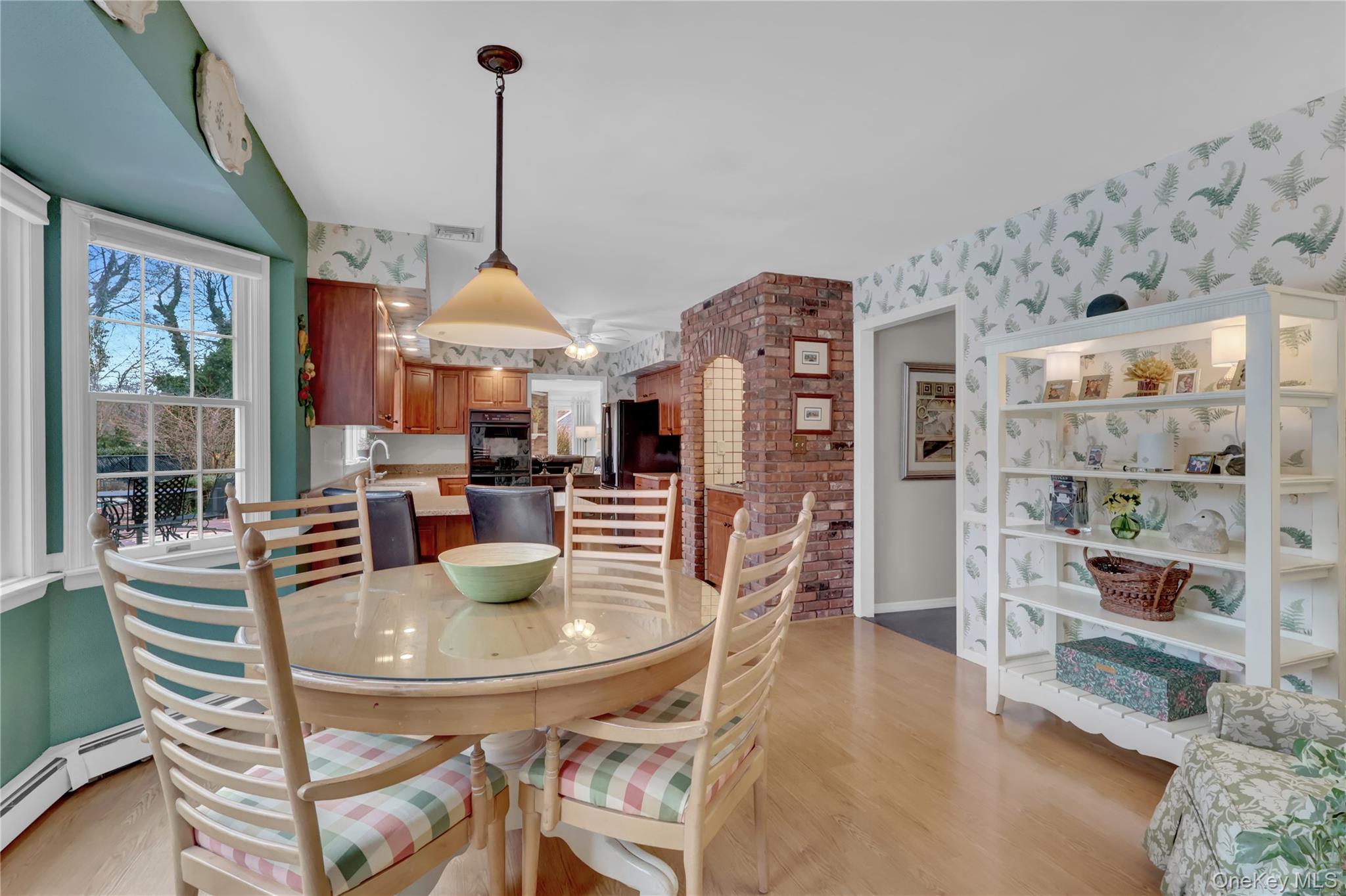 6 Samuels Path Miller Place, NY 11764 - Photo 15 of 47 a dining room with furniture a chandelier and wooden floor