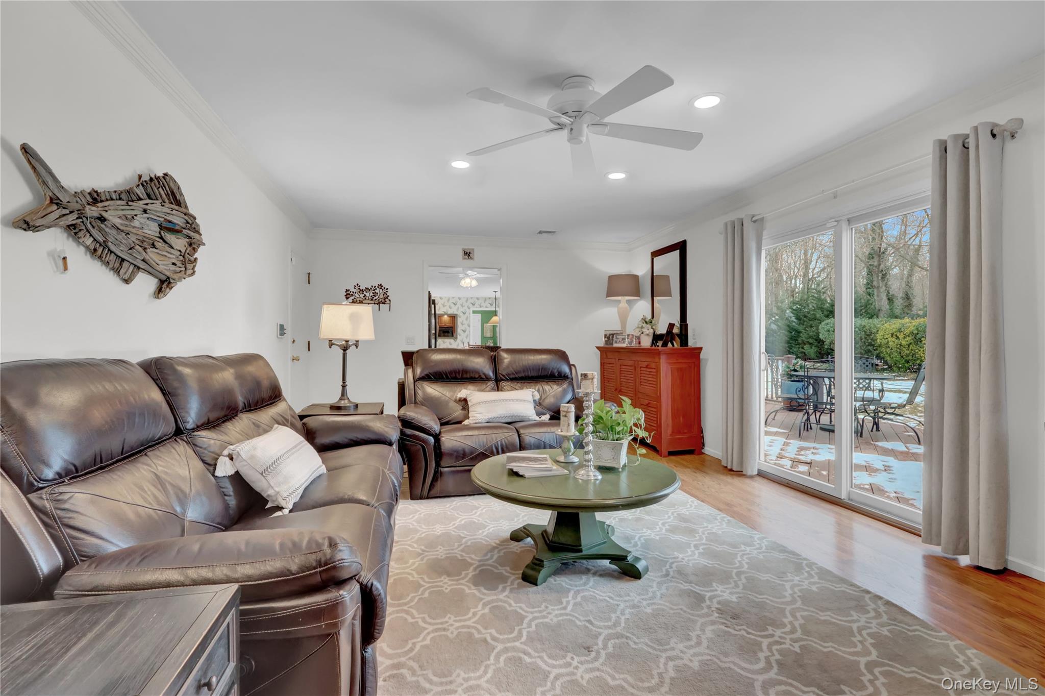 6 Samuels Path Miller Place, NY 11764 - Photo 22 of 47 a living room with furniture a floor to ceiling window and a flat screen tv