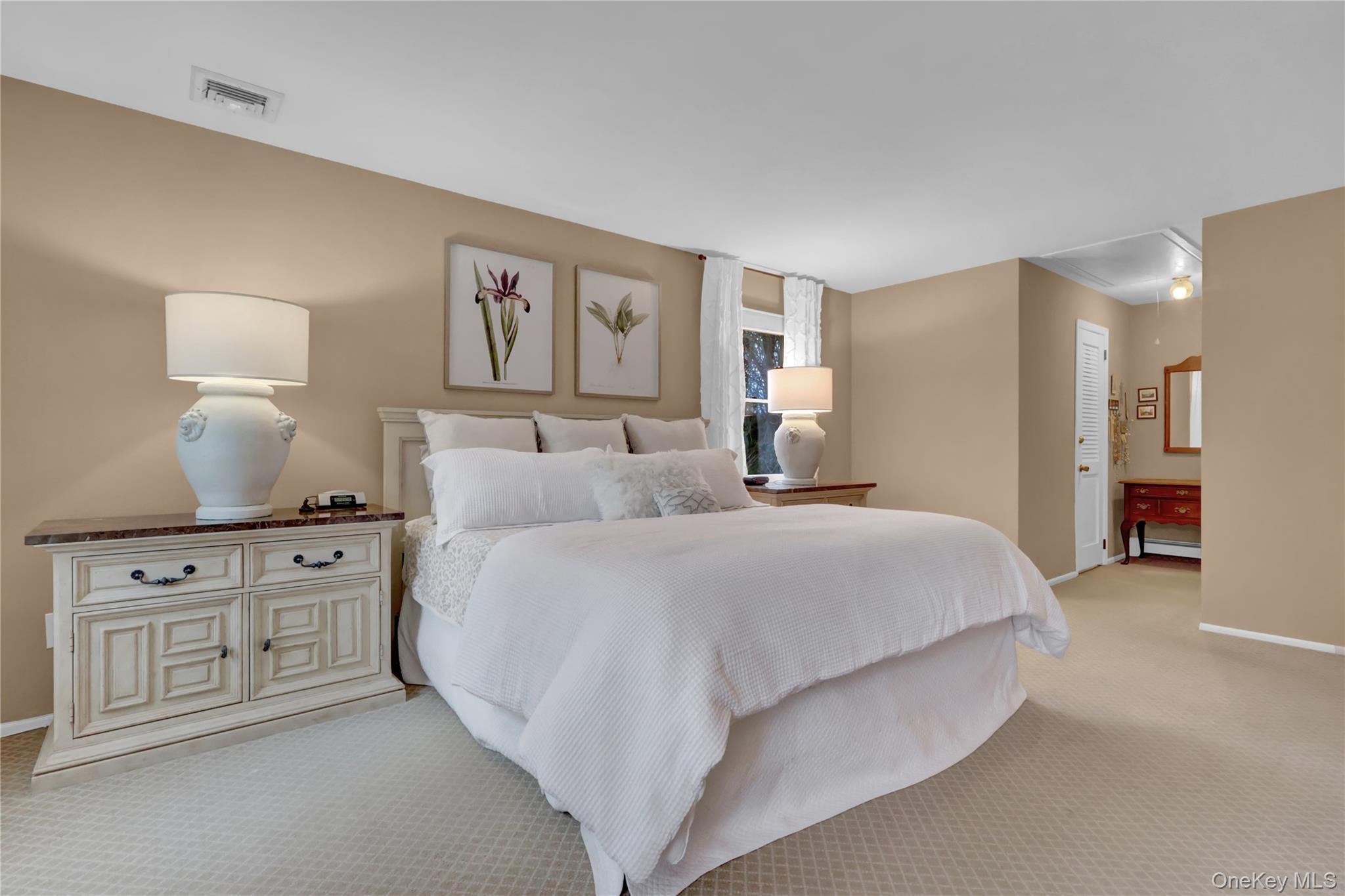 6 Samuels Path Miller Place, NY 11764 - Photo 27 of 47 a spacious bedroom with a bed and a lamp