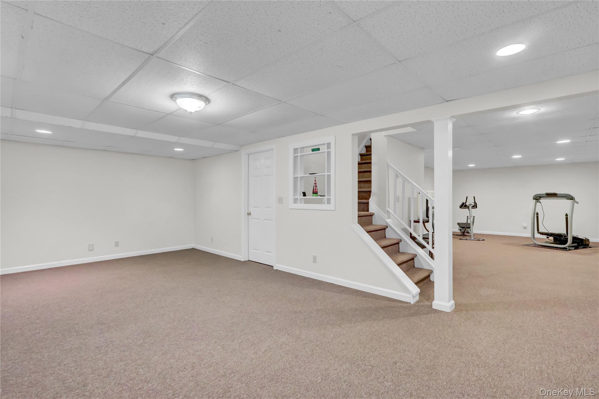 6 Samuels Path Miller Place, NY 11764 - Photo 36 of 47 an empty room with white walls and stairs