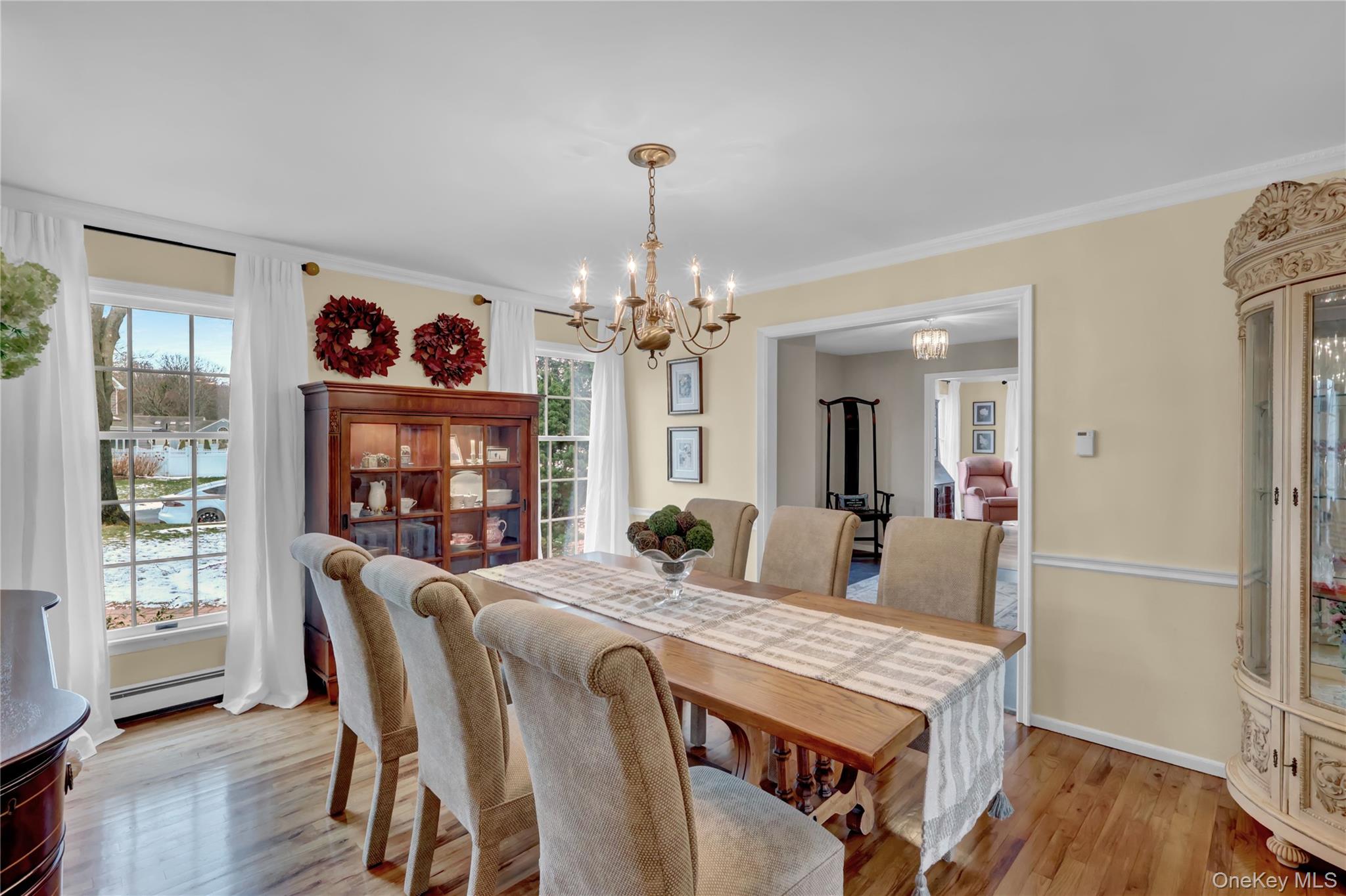 6 Samuels Path Miller Place, NY 11764 - Photo 9 of 47 a view of a dining room with furniture a chandelier and wooden floor