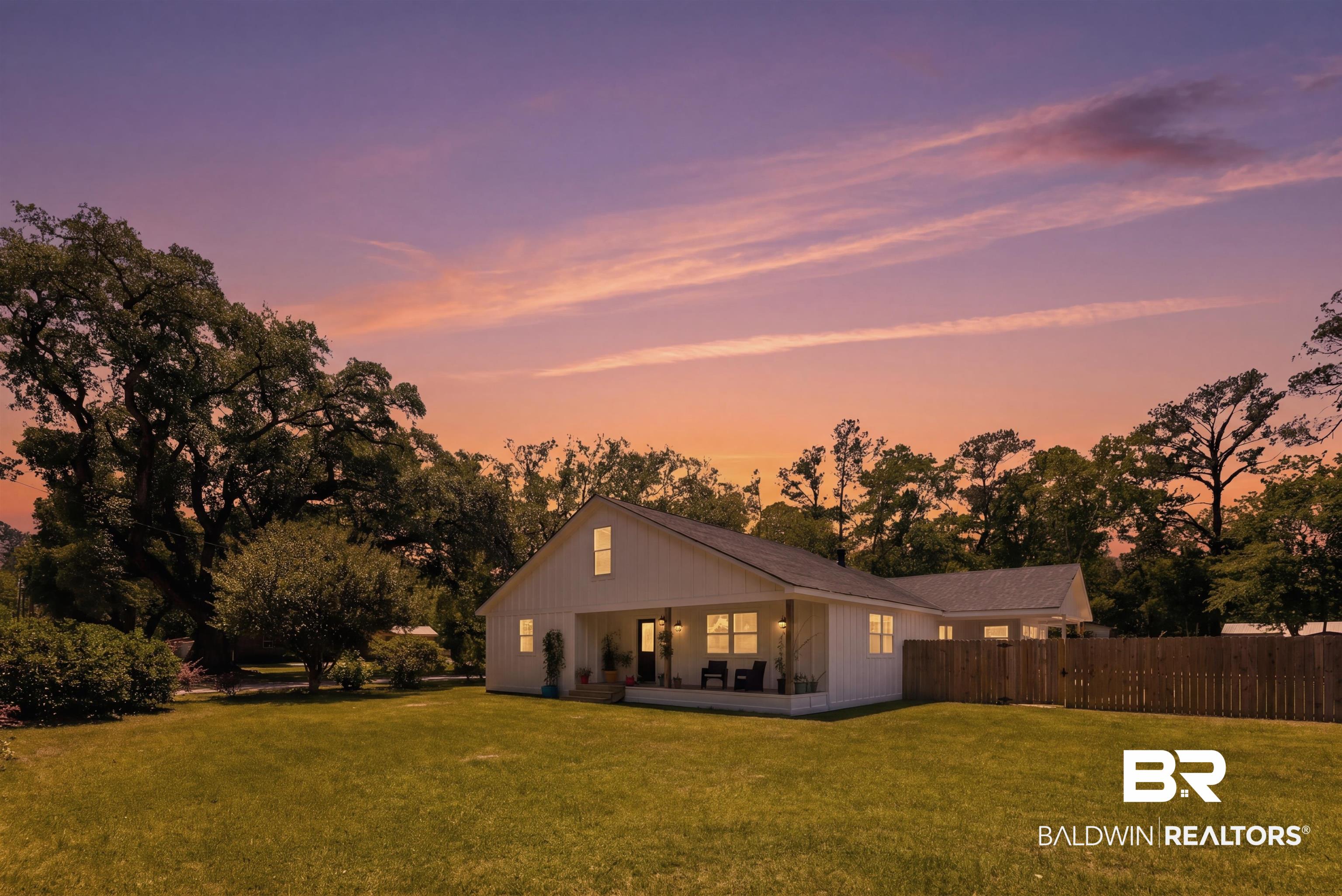 6447 Bemis Lane Bon Secour, AL 36511 - Photo 2 of 62 White modern farmhouse style residence featuring a covered front porch, a gabled roofline, and board-and-batten siding