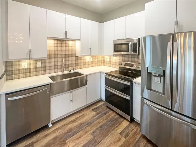 a kitchen with stainless steel appliances a refrigerator and stove