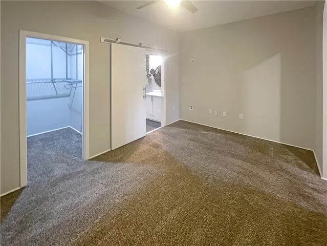 a view of an empty room and closet area