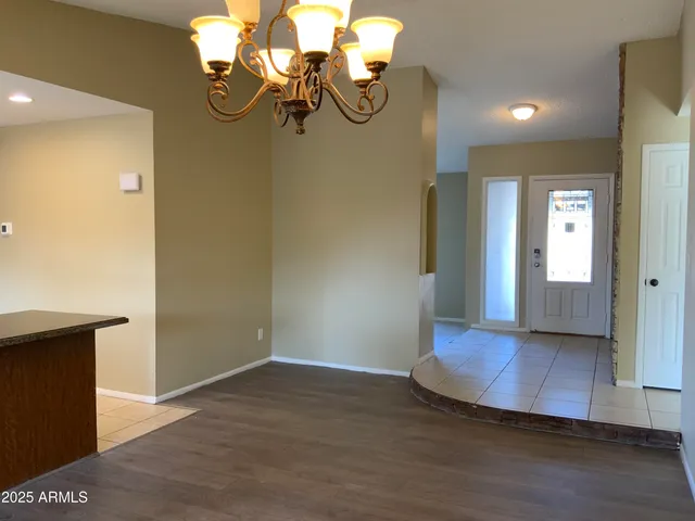a view of an entryway with wooden floor