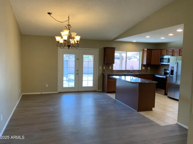 a large kitchen with granite countertop a stove top oven a sink and dishwasher