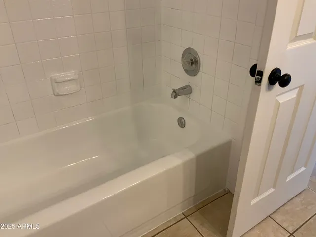a bathroom with a shower and a tub