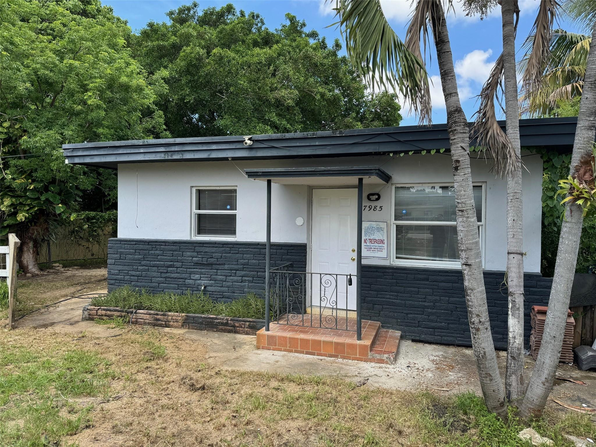 7979 Northwest 1st Place, Unit 2 Miami, FL 33150 - Photo 1 of 15 a front view of a house with a yard