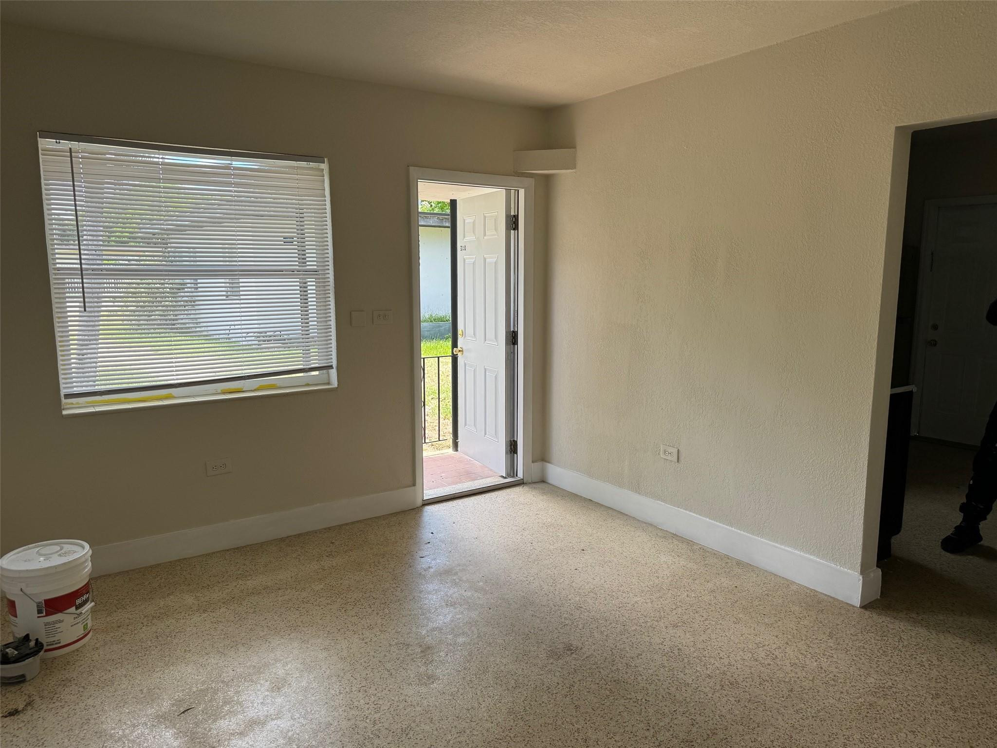 7979 Northwest 1st Place, Unit 2 Miami, FL 33150 - Photo 4 of 15 a view of an empty room with a window and a bathroom