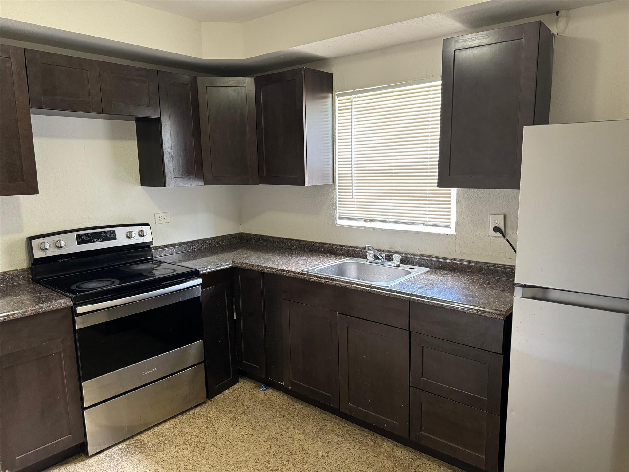 7979 Northwest 1st Place, Unit 2 Miami, FL 33150 - Photo 5 of 15 a kitchen with granite countertop cabinets and window