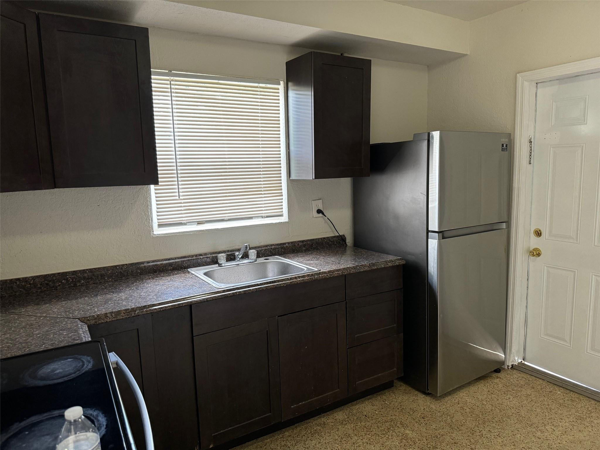 7979 Northwest 1st Place, Unit 2 Miami, FL 33150 - Photo 6 of 15 a kitchen with a refrigerator and a sink
