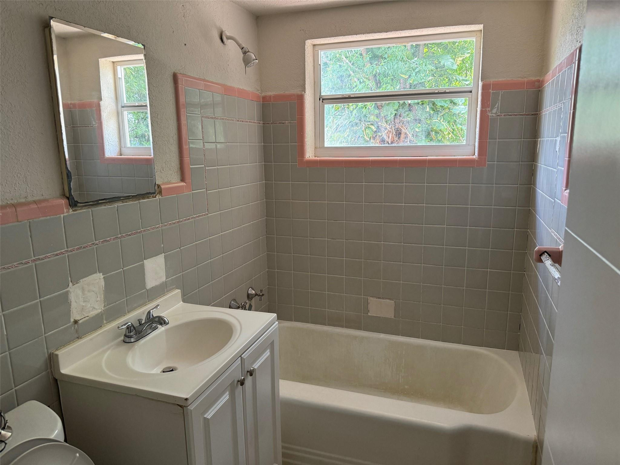 7979 Northwest 1st Place, Unit 2 Miami, FL 33150 - Photo 8 of 15 a bathroom with a sink toilet and shower