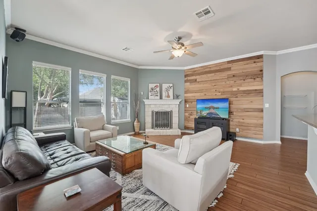 a living room with furniture fireplace and a flat screen tv