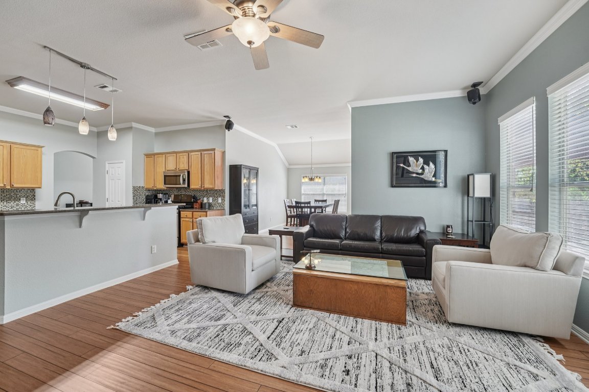 1105 Pigeon Forge Road Pflugerville, TX 78660 - Photo 12 of 19 a living room with furniture and a wooden floor