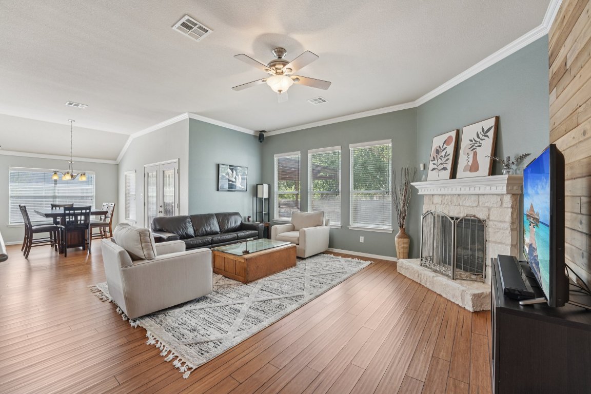 1105 Pigeon Forge Road Pflugerville, TX 78660 - Photo 13 of 19 a living room with furniture and a fireplace