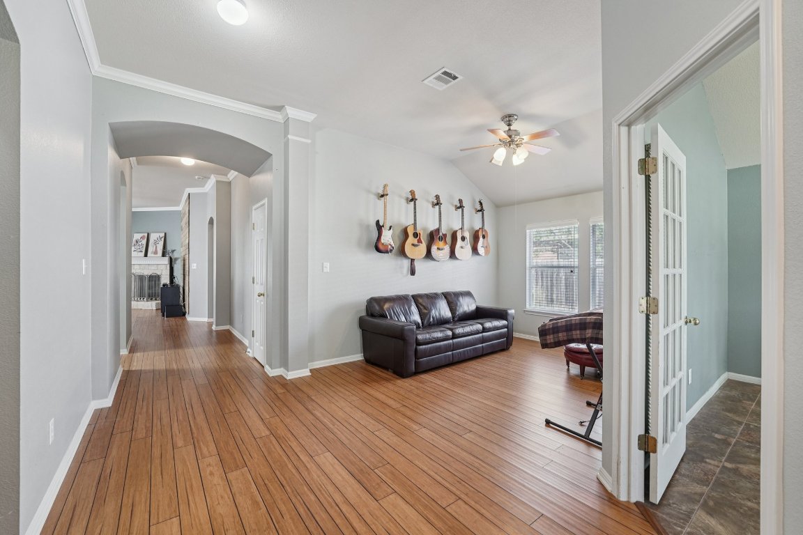 1105 Pigeon Forge Road Pflugerville, TX 78660 - Photo 3 of 19 a living room with furniture and wooden floor