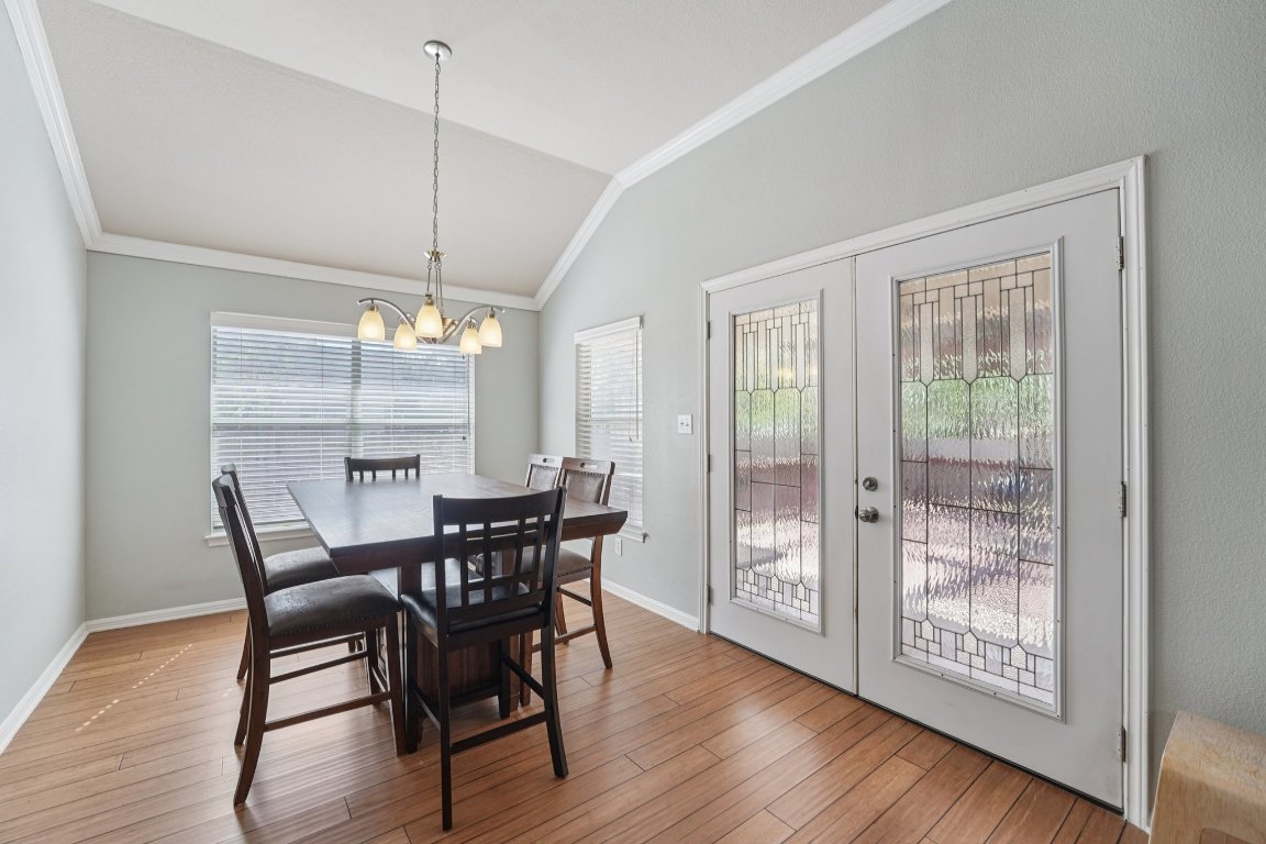 1105 Pigeon Forge Road Pflugerville, TX 78660 - Photo 4 of 19 a view of a dining room with furniture window and wooden floor