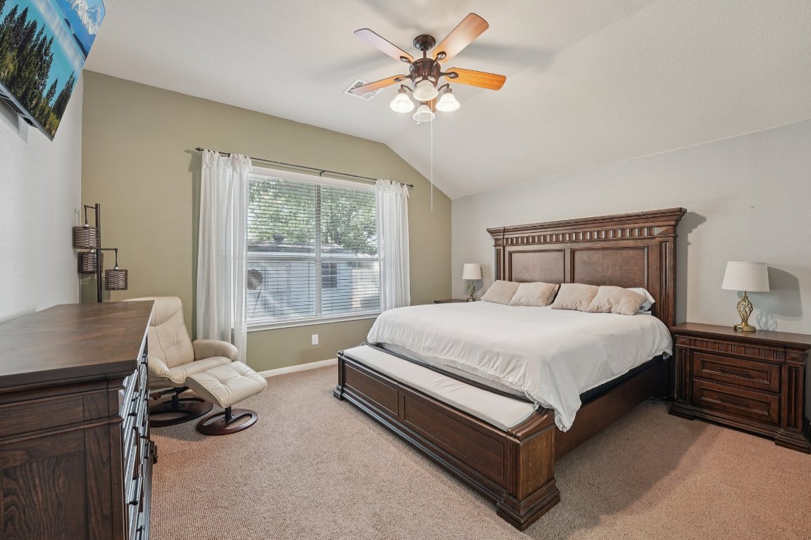 1105 Pigeon Forge Road Pflugerville, TX 78660 - Photo 5 of 19 a bedroom with a bed and a chandelier