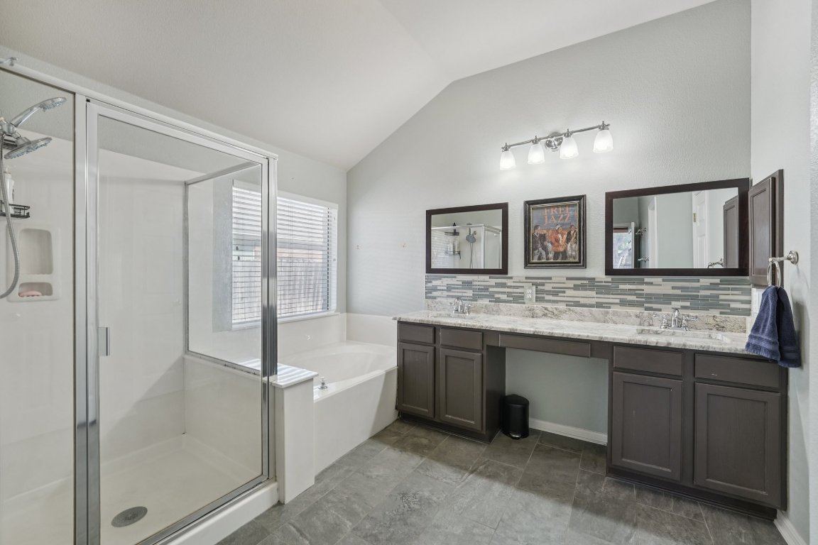 1105 Pigeon Forge Road Pflugerville, TX 78660 - Photo 6 of 19 a bathroom with a granite countertop sink and a mirror