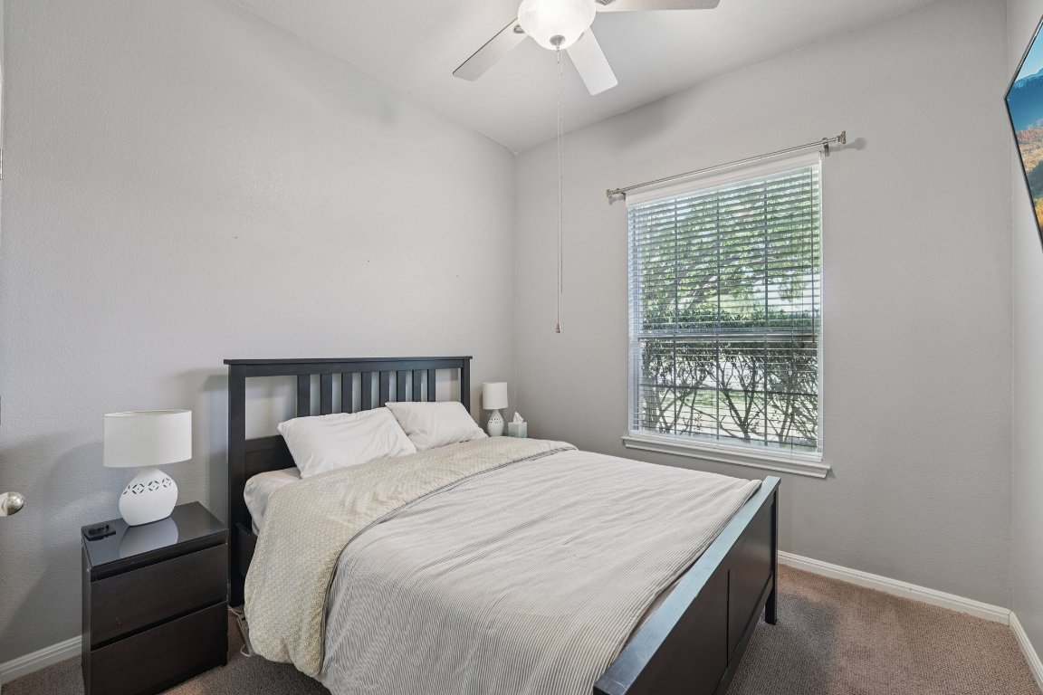 1105 Pigeon Forge Road Pflugerville, TX 78660 - Photo 8 of 19 a bedroom with a bed and a window