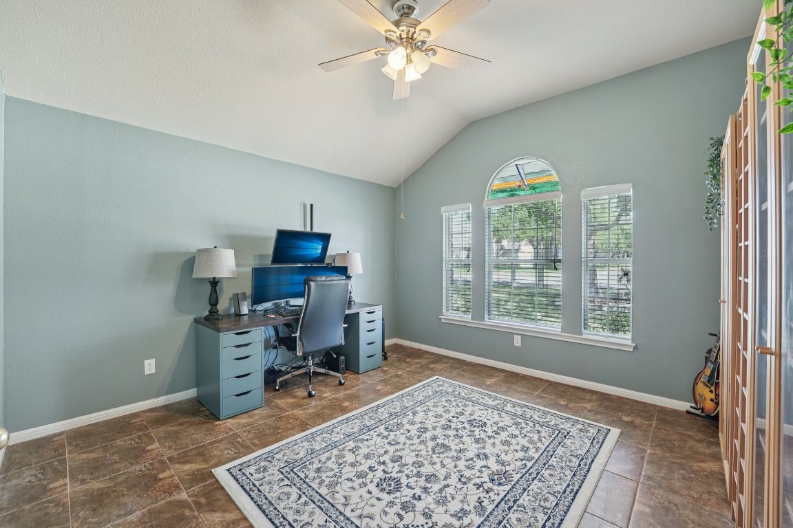 1105 Pigeon Forge Road Pflugerville, TX 78660 - Photo 9 of 19 a view of a workspace with furniture and a window