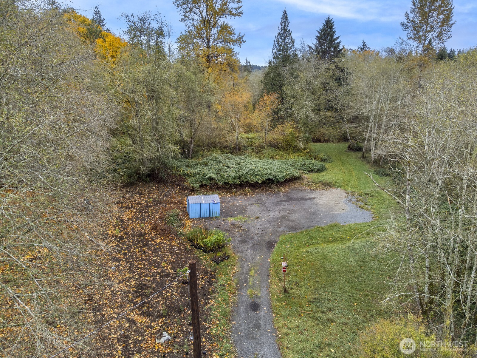 7714-7722 Grandview Road Arlington, WA 98223 - Photo 4 of 14 a view of a yard with plants and a bench