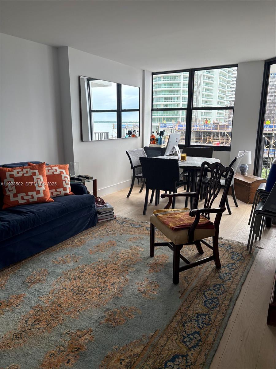 1865 Brickell Avenue, Unit A604 Miami, FL 33129 - Photo 5 of 18 a living room with furniture and a large window