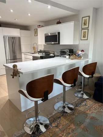 a kitchen with a table and chairs