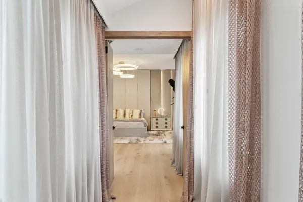 a bedroom with a bed and a chandelier