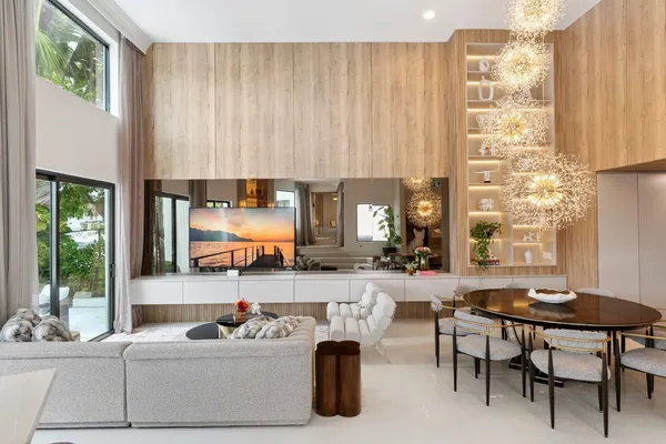 a living room with fireplace furniture and a large window