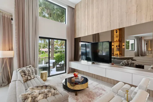 a living room with furniture and a chandelier