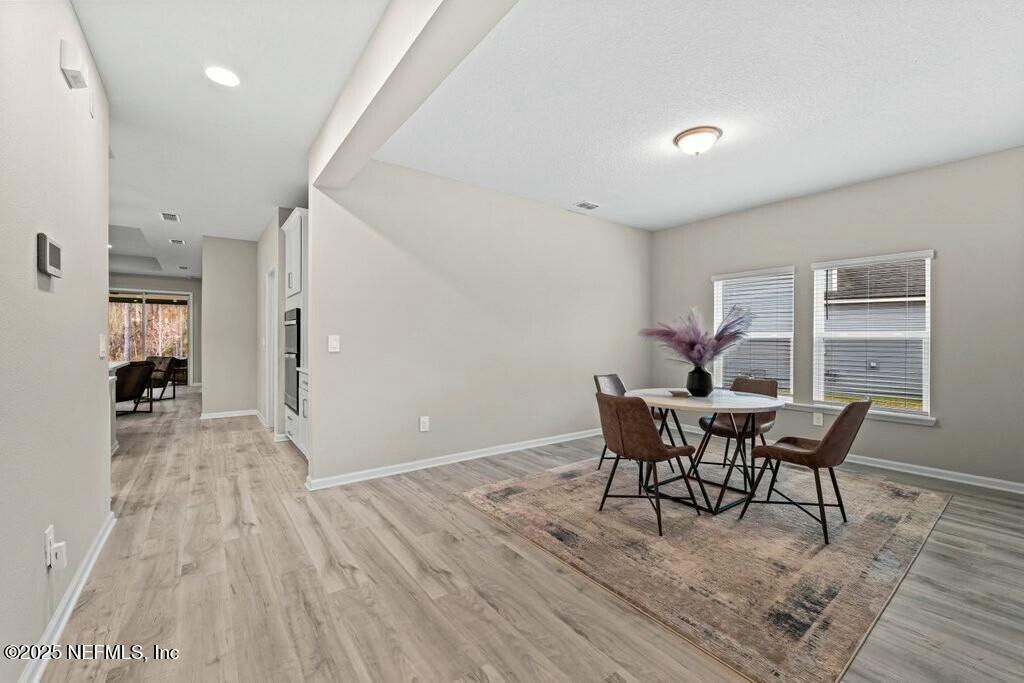 469 Archstone Way St. Augustine, FL 32092 - Photo 12 of 59 a view of a dining room with furniture and wooden floor
