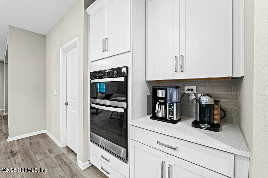 469 Archstone Way St. Augustine, FL 32092 - Photo 20 of 59 a kitchen with white cabinets and stainless steel appliances