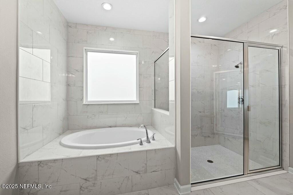 469 Archstone Way St. Augustine, FL 32092 - Photo 36 of 59 a bathroom with a bathtub and a shower