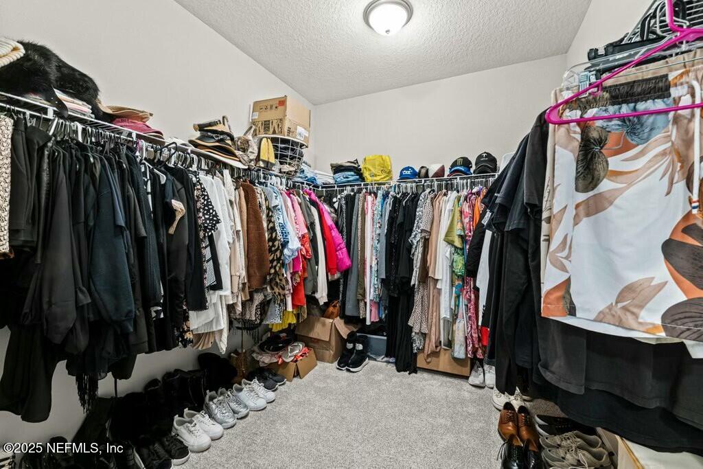 469 Archstone Way St. Augustine, FL 32092 - Photo 41 of 59 a view of walk in closet with clothes