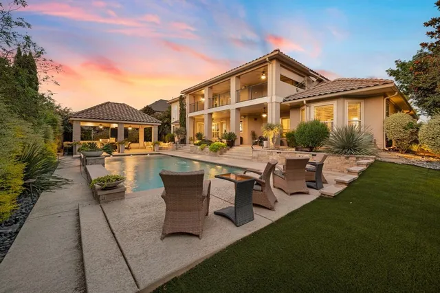 a view of a house with backyard porch and sitting area