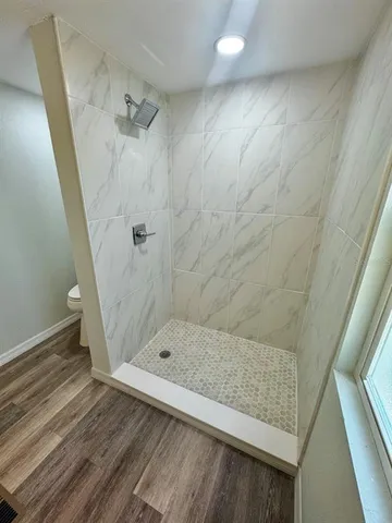 a view of a room that has a sink and a mirror