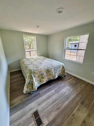 a view of a water fountain with large trees