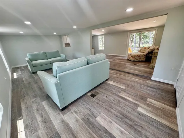 a living room with furniture and a potted plant