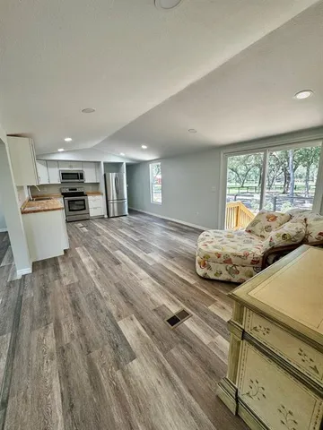 a bedroom with furniture and large windows