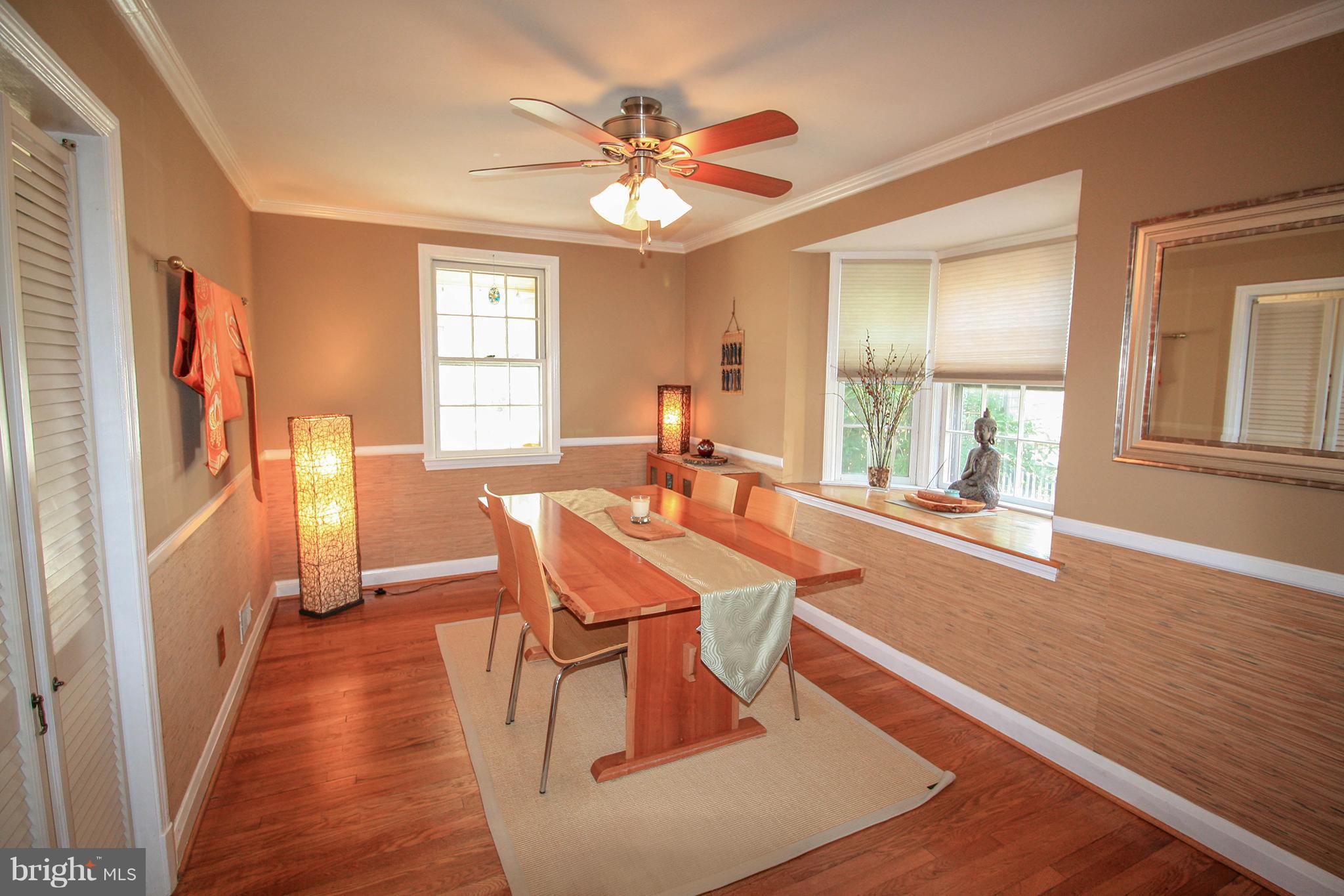 8427 Pleasant Plains Road Baltimore, MD 21286 - Photo 11 of 30 a dining room with wooden floor and large window