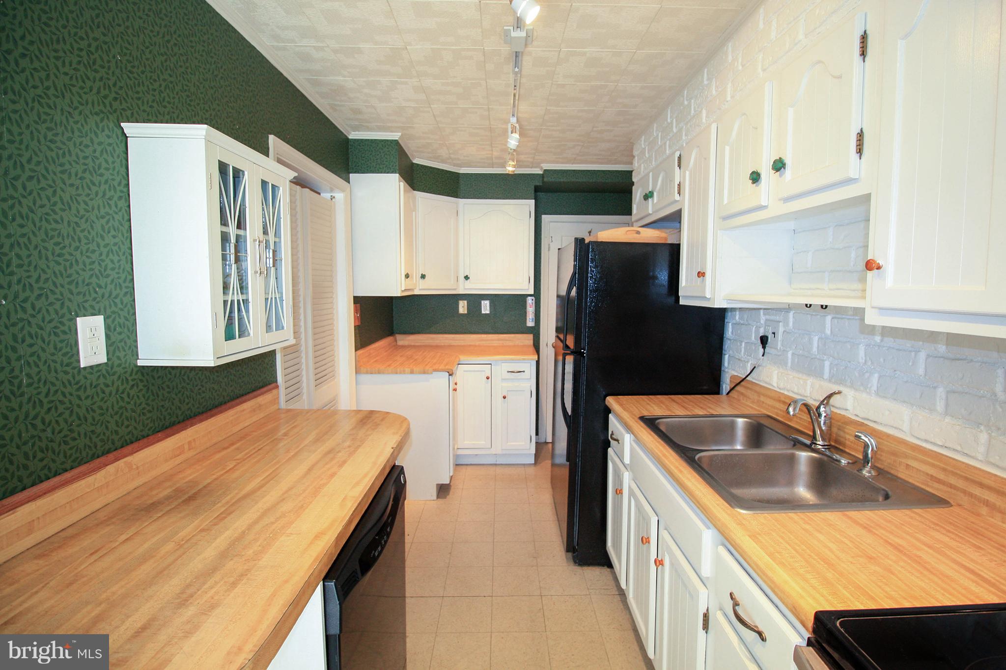 8427 Pleasant Plains Road Baltimore, MD 21286 - Photo 13 of 30 a kitchen with stainless steel appliances granite countertop a sink refrigerator and microwave