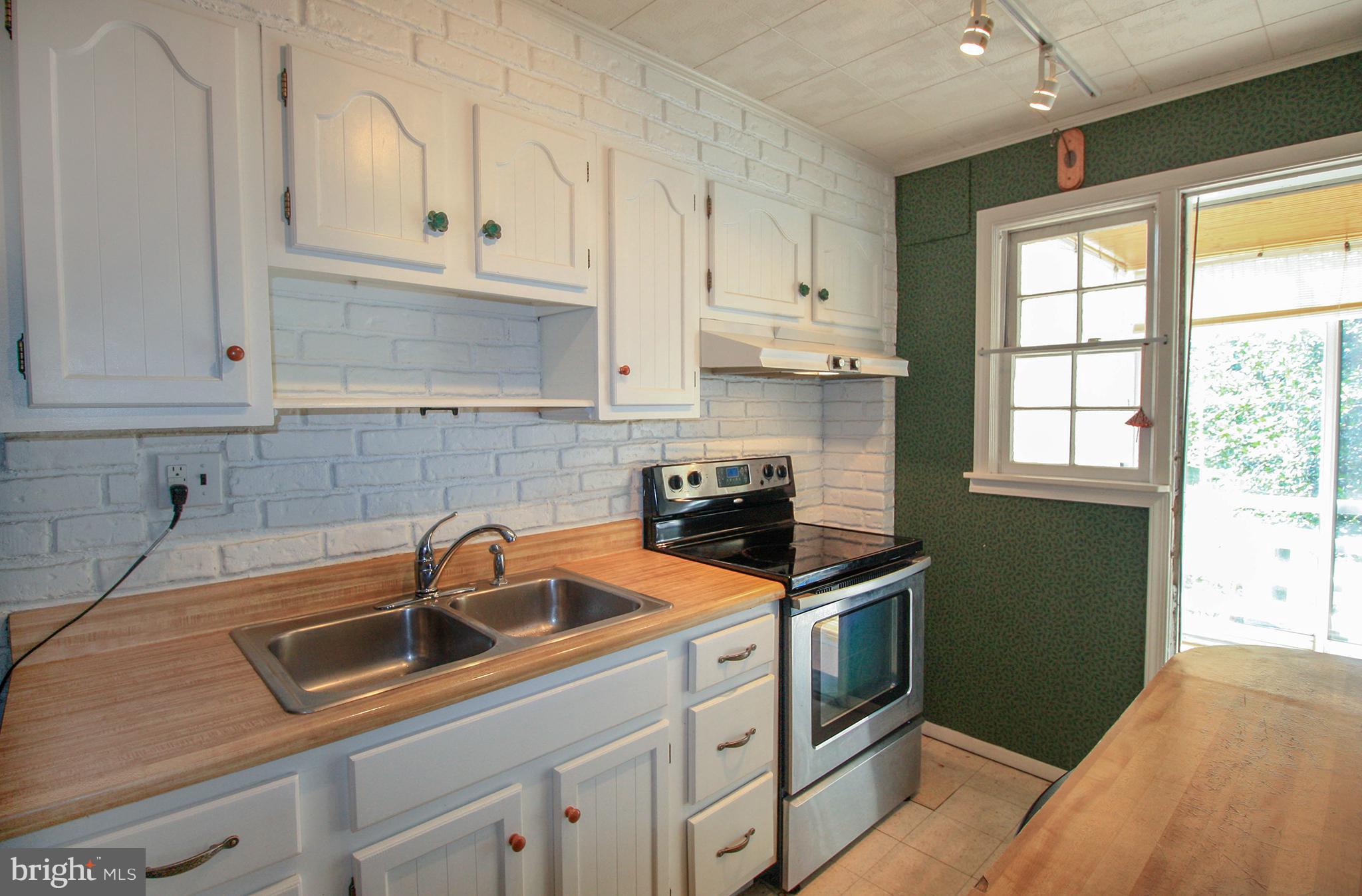 8427 Pleasant Plains Road Baltimore, MD 21286 - Photo 14 of 30 a kitchen that has a sink and a stove