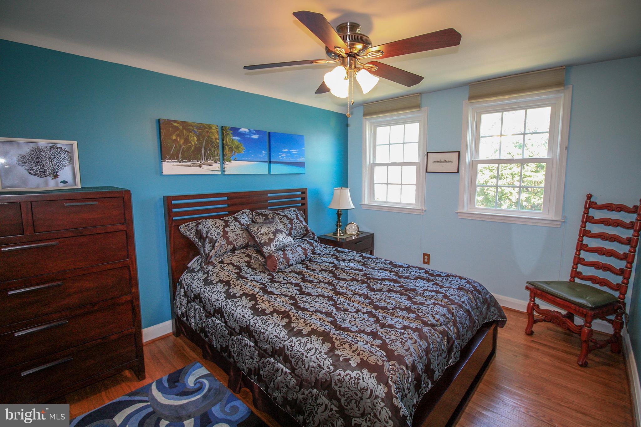 8427 Pleasant Plains Road Baltimore, MD 21286 - Photo 19 of 30 a bedroom with a bed and a dresser next to a window