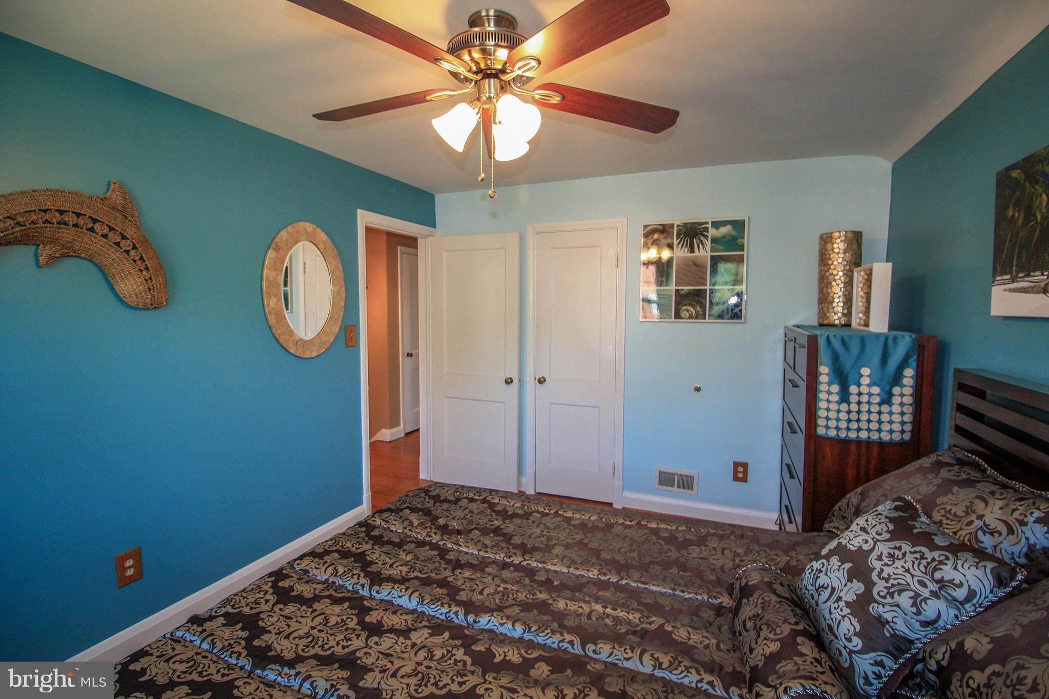8427 Pleasant Plains Road Baltimore, MD 21286 - Photo 20 of 30 a bedroom with a bed and a chandelier