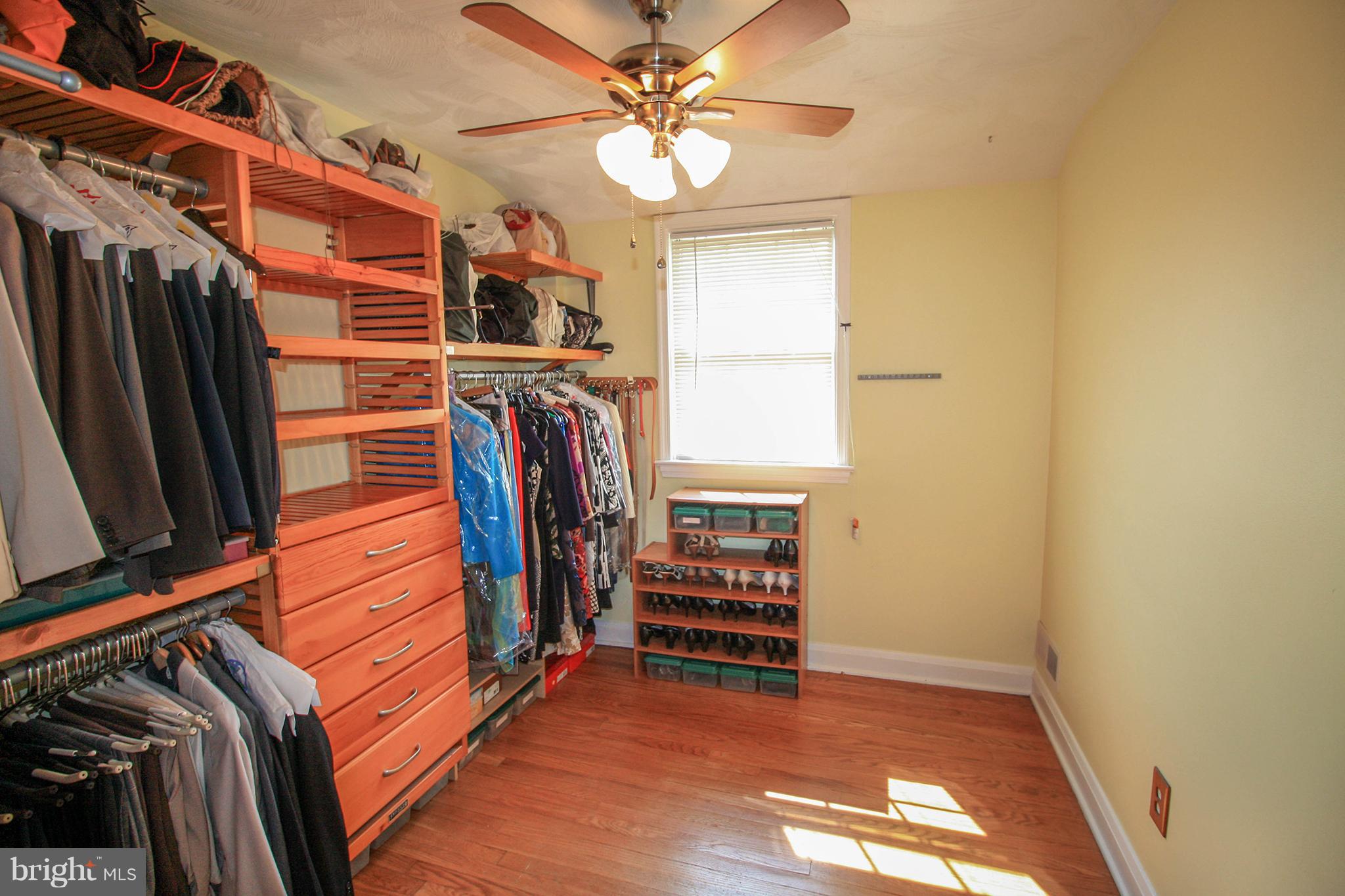 8427 Pleasant Plains Road Baltimore, MD 21286 - Photo 23 of 30 a view of walk in closet with clothes and shoes
