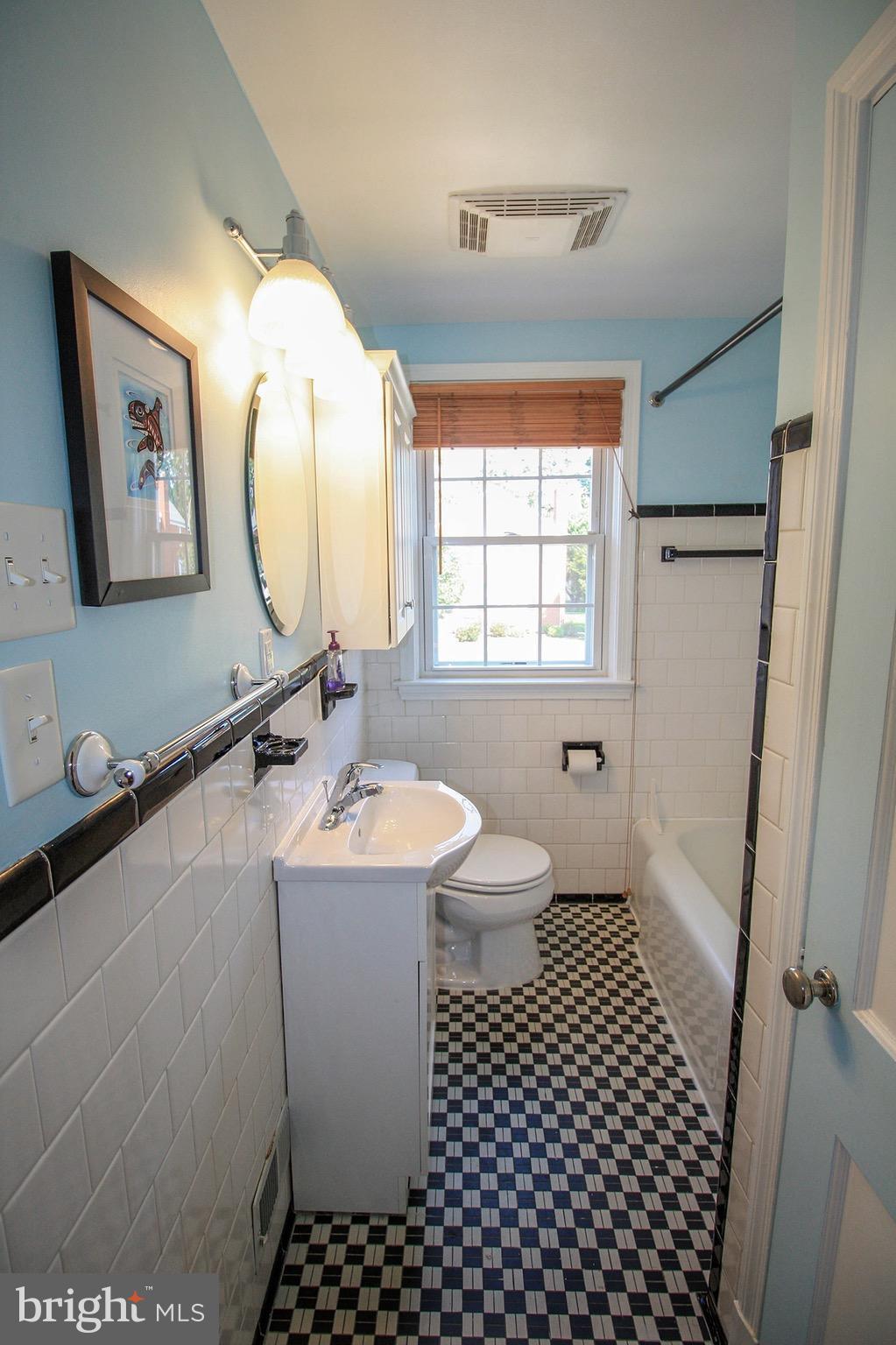 8427 Pleasant Plains Road Baltimore, MD 21286 - Photo 25 of 30 a bathroom with a sink toilet a mirror and vanity