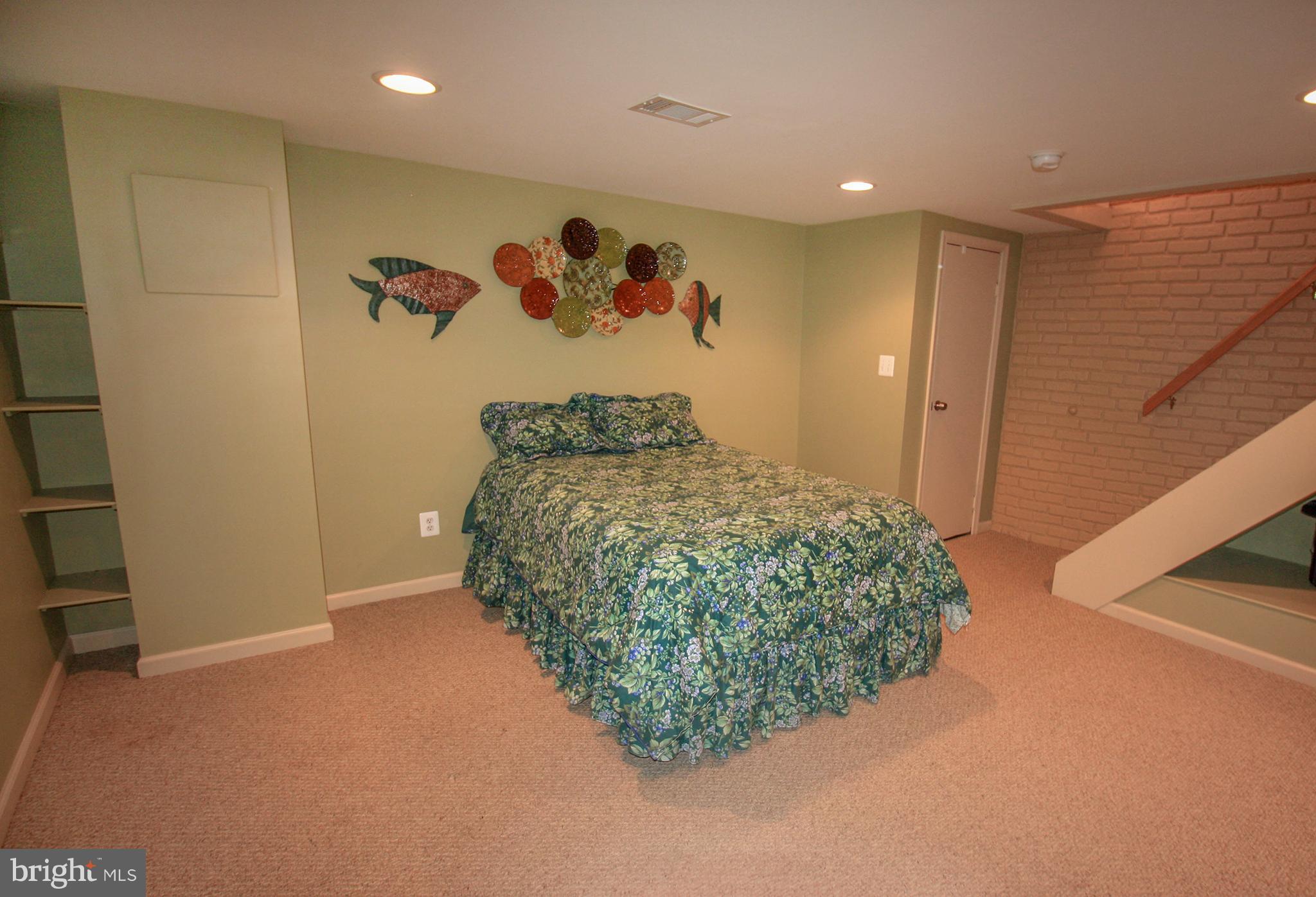 8427 Pleasant Plains Road Baltimore, MD 21286 - Photo 26 of 30 a bedroom with a large bed and a painting on the wall
