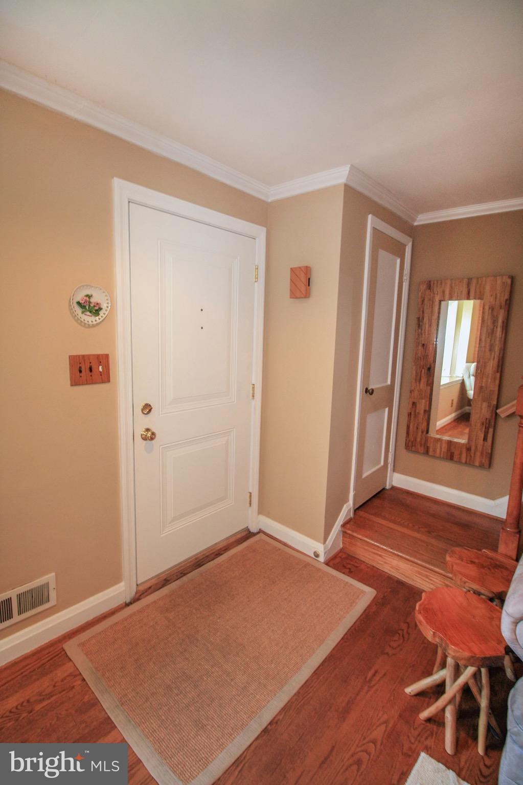 8427 Pleasant Plains Road Baltimore, MD 21286 - Photo 6 of 30 an empty room with wooden floor and windows